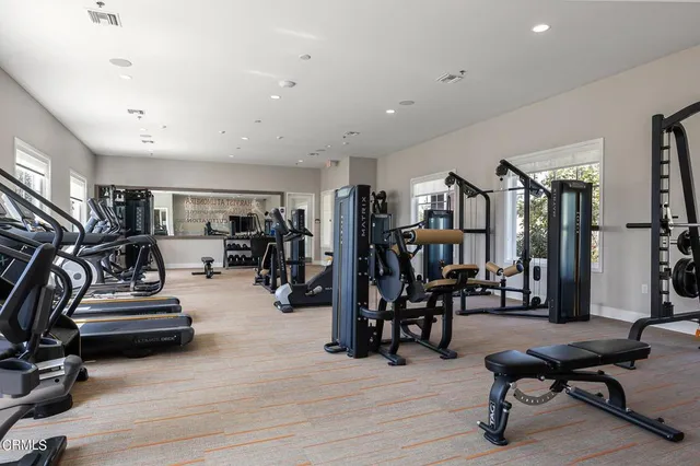 a view of a room with gym equipment and lots of equipment