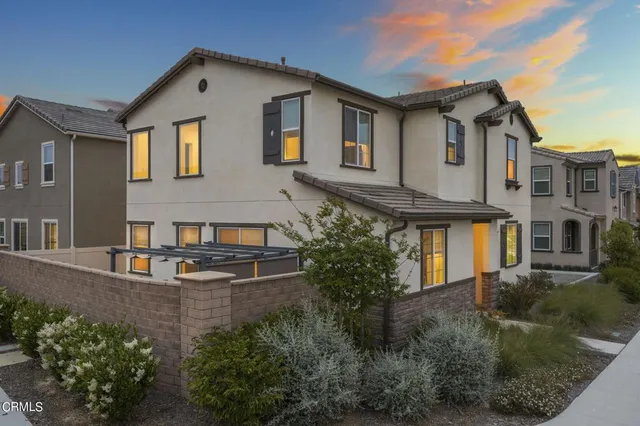 a front view of a house with plants