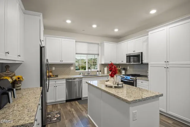 a kitchen that has a sink and a stove in it