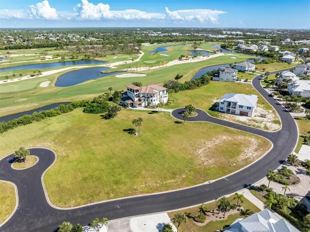 an aerial view of a swimming pool with outdoor seating