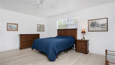 a bedroom with a bed and a dresser