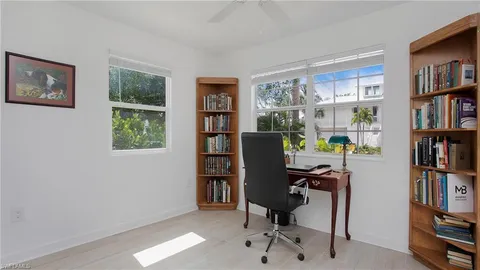 a view of a workspace with bookshelf