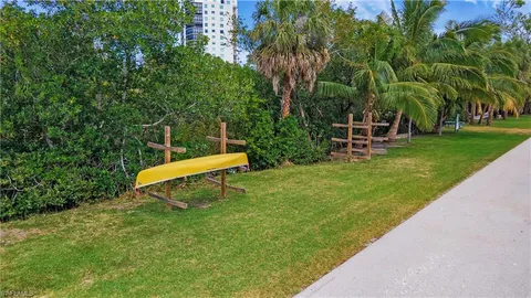 a garden with a bench and trees