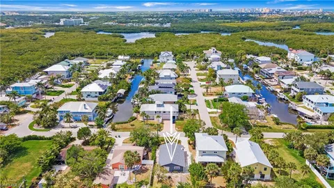 an aerial view of residential houses with outdoor space and river