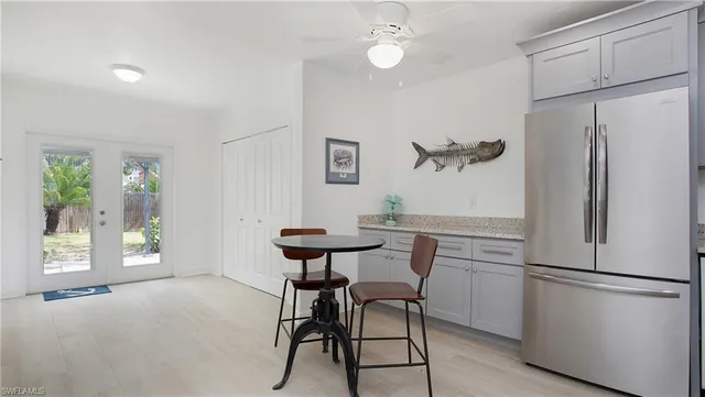 a kitchen with stainless steel appliances a refrigerator and a table