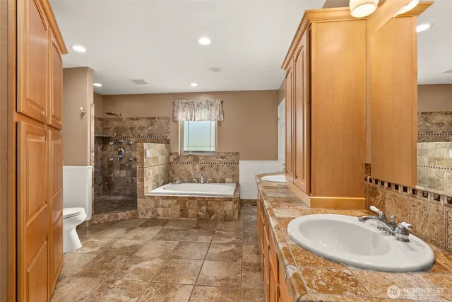 a bathroom with a sink toilet and shower