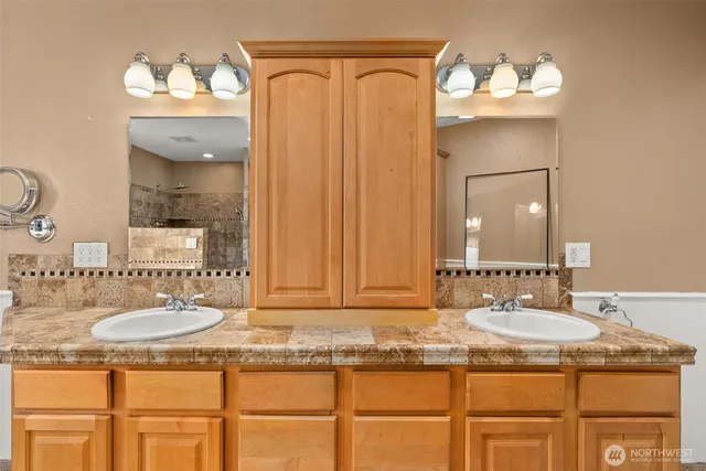 a bathroom with a sink vanity and a mirror