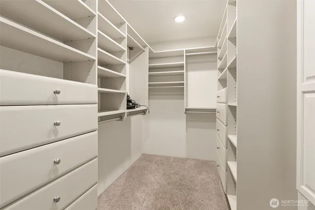 a bedroom with a bed and a dresser in it