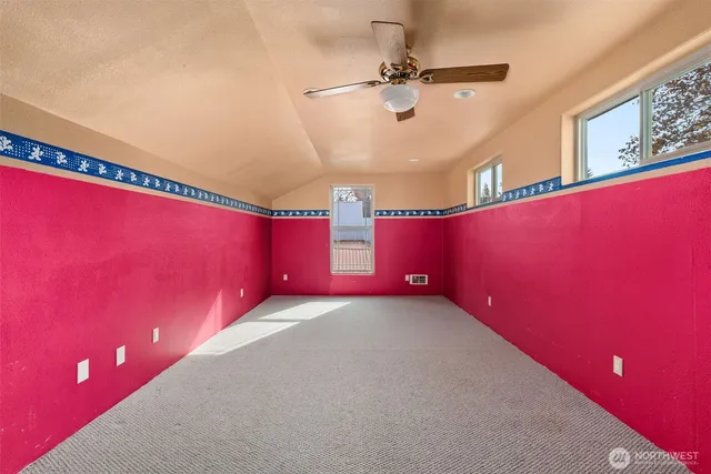 a kitchen with stainless steel appliances a stove a sink and a refrigerator with white cabinets