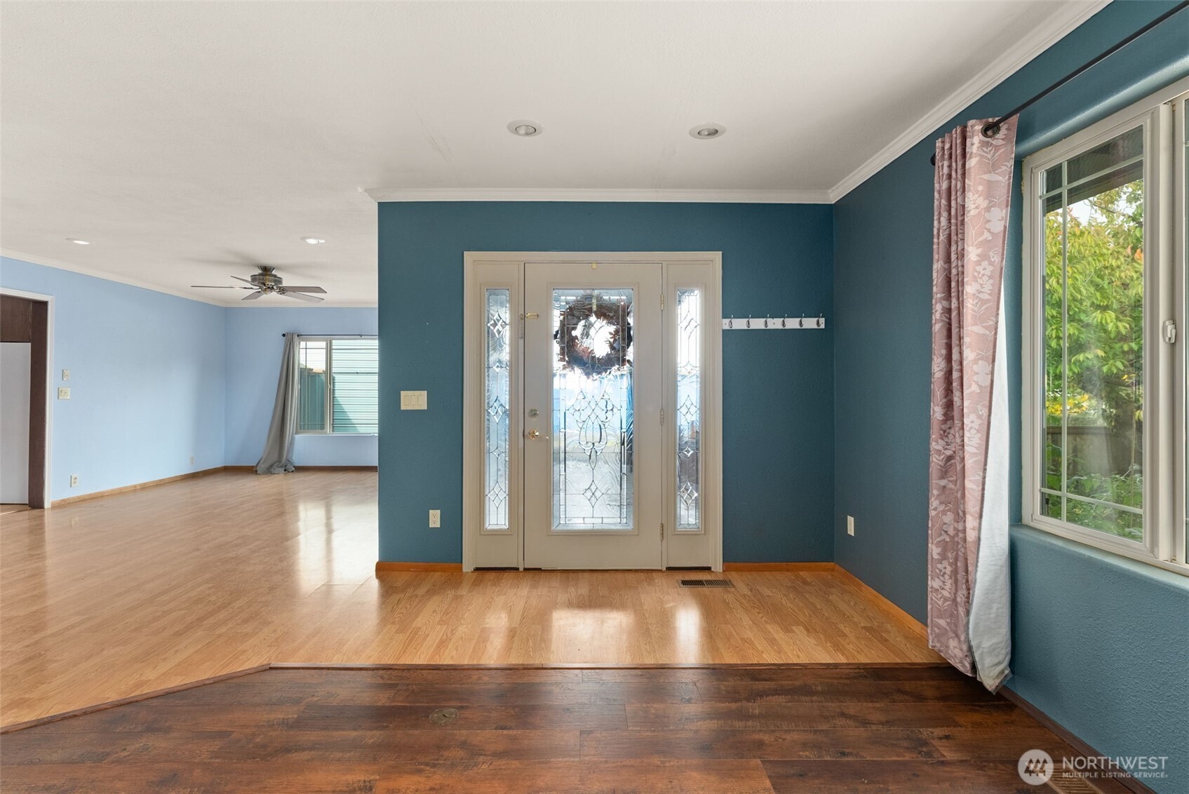 998 SR 6 Raymond, WA 98577 - Photo 6 of 38 a view of an empty room with window and wooden floor