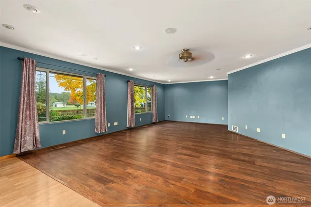 an empty room with large windows