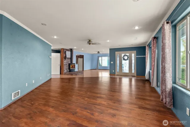 a view of a livingroom with a furniture wooden floor and a window