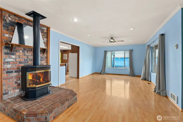 a view of an empty room with window and fire place