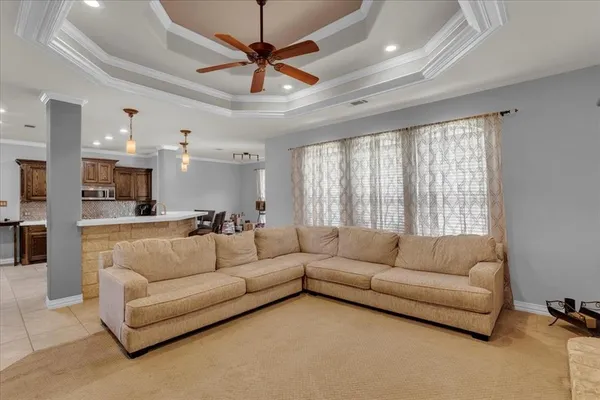 a kitchen with granite countertop white cabinets and black appliances