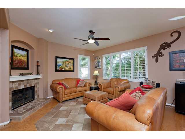 2813 Rancho Rio Chico Carlsbad, CA 92009 - Photo 5 of 23 Wonderful family room with hardwood flooring, cozy fireplace with custom tile surrounding it, and windows abound!
