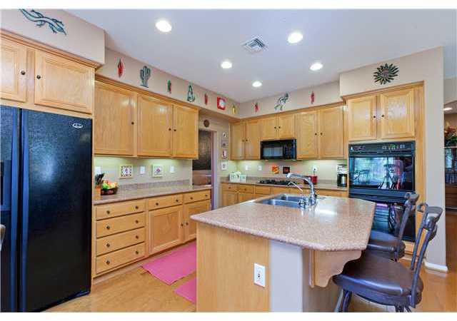2813 Rancho Rio Chico Carlsbad, CA 92009 - Photo 6 of 23 Gourmet kitchen with center island, breakfast nook area, computer area, double ovens, refrigerator conveys.
