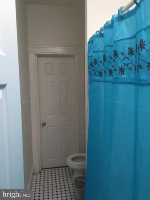 634 Rappolla Street Baltimore, MD 21224 - Photo 22 of 30 a bathroom with a granite countertop toilet and a shower