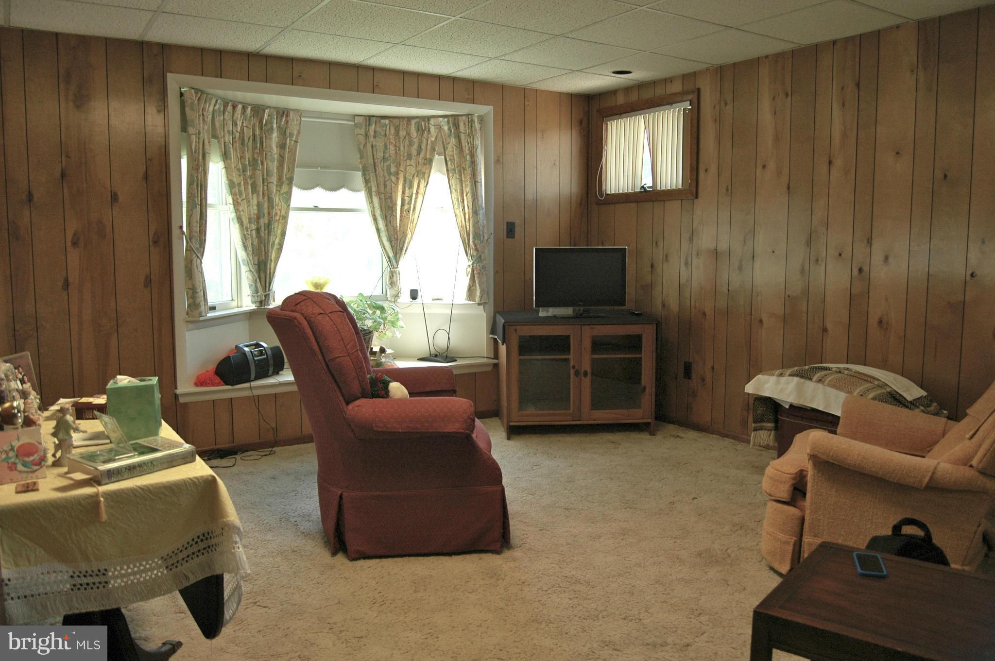 3517 Ellen Road Windsor Mill, MD 21244 - Photo 2 of 30 a living room with furniture and a flat screen tv