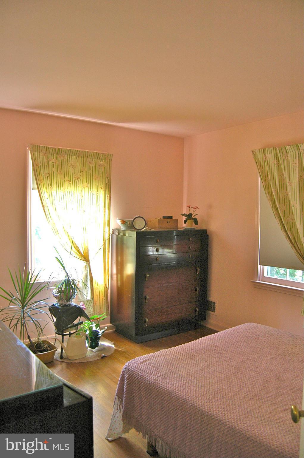 3517 Ellen Road Windsor Mill, MD 21244 - Photo 12 of 30 a bedroom with a bed and a painting on the wall