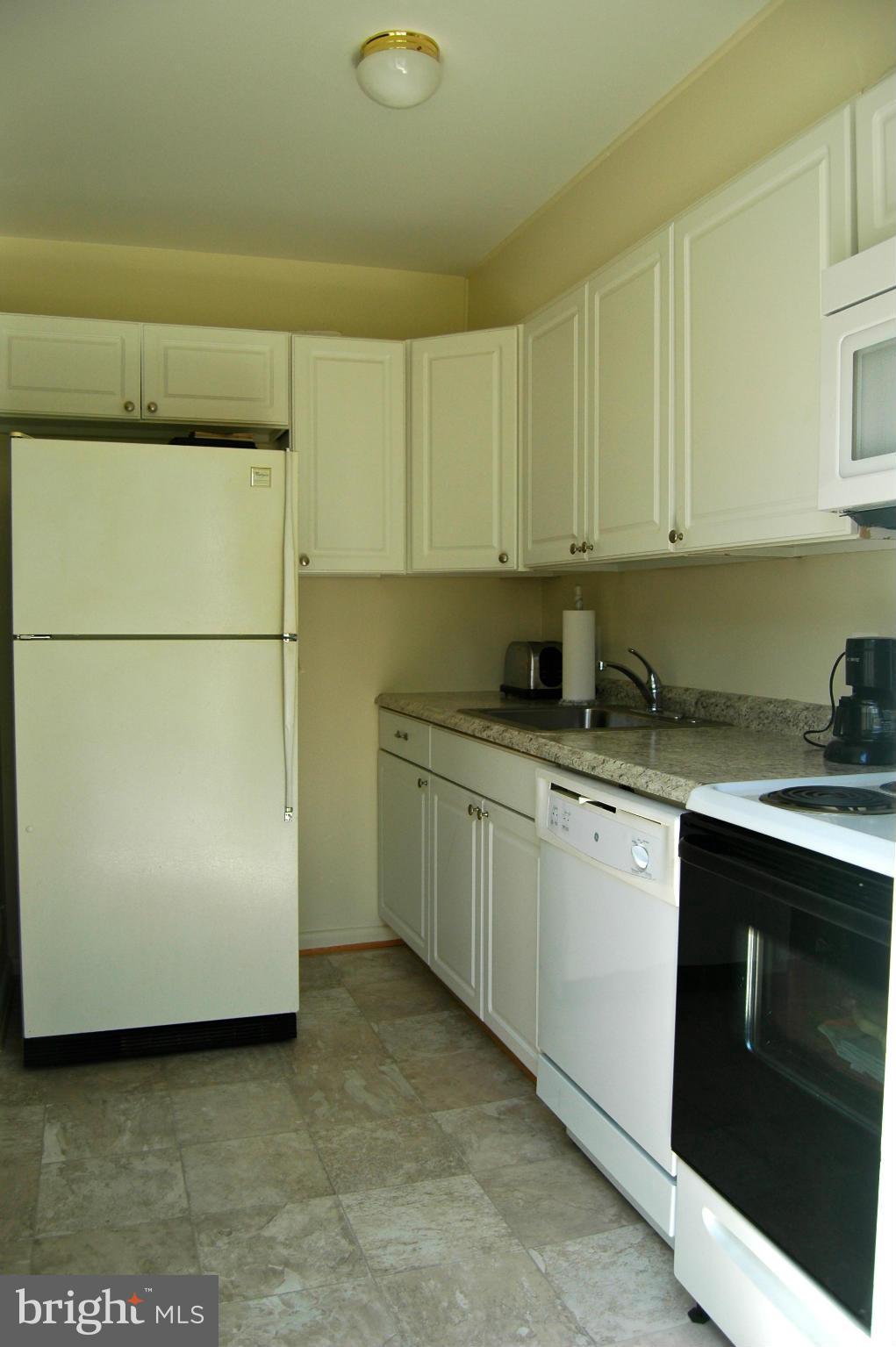 3517 Ellen Road Windsor Mill, MD 21244 - Photo 6 of 30 a kitchen with granite countertop cabinets stainless steel appliances and a counter space