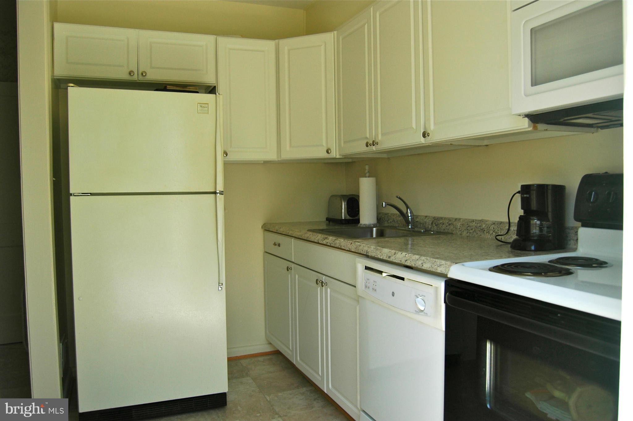 3517 Ellen Road Windsor Mill, MD 21244 - Photo 7 of 30 a white refrigerator freezer sitting inside of a kitchen