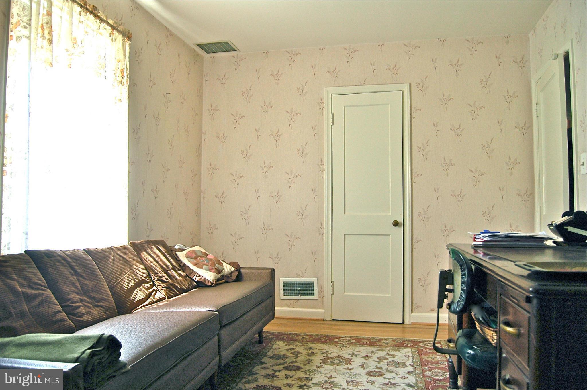 3517 Ellen Road Windsor Mill, MD 21244 - Photo 10 of 30 a living room with a couch and a stove next to a window