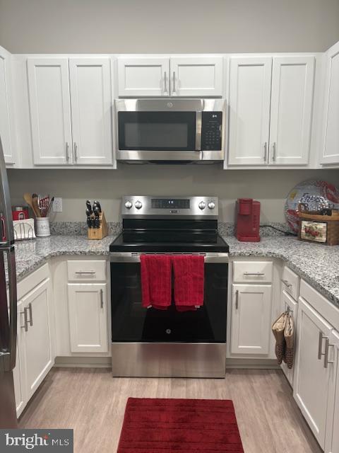 30609 Cedar Neck Road, Unit 3109 Ocean View, DE 19970 - Photo 20 of 44 a kitchen with stainless steel appliances granite countertop a stove a microwave and cabinets