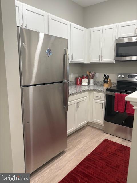 30609 Cedar Neck Road, Unit 3109 Ocean View, DE 19970 - Photo 21 of 44 a white refrigerator freezer sitting inside of a kitchen