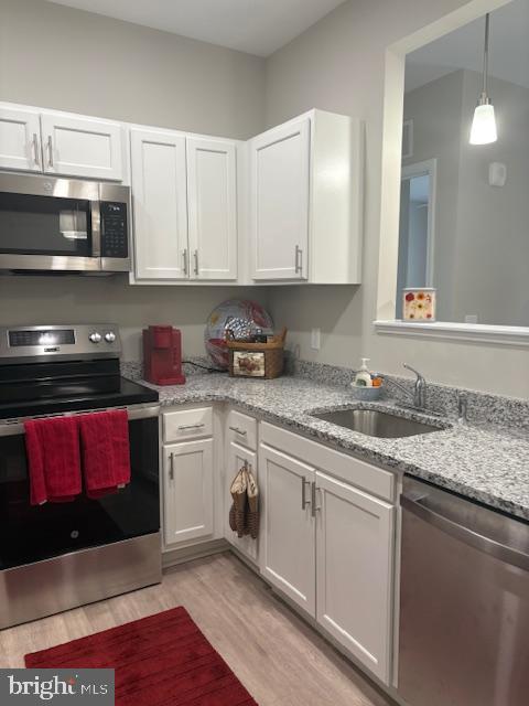 30609 Cedar Neck Road, Unit 3109 Ocean View, DE 19970 - Photo 22 of 44 a kitchen with stainless steel appliances granite countertop a stove a sink and a microwave