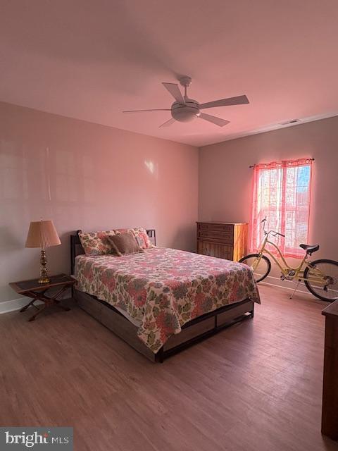 30609 Cedar Neck Road, Unit 3109 Ocean View, DE 19970 - Photo 30 of 44 a bedroom with a bed and wooden floor