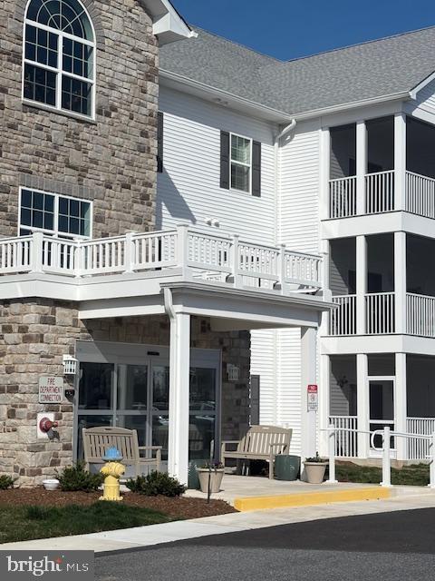 30609 Cedar Neck Road, Unit 3109 Ocean View, DE 19970 - Photo 4 of 44 a front view of a building with glass windows