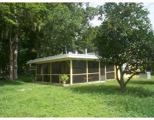 56520 Elm Road Astor, FL 32102 - Photo 1 of 1 Exterior Front - Wonderful 22 x 20 screened covered porch with sliding glass doors into home