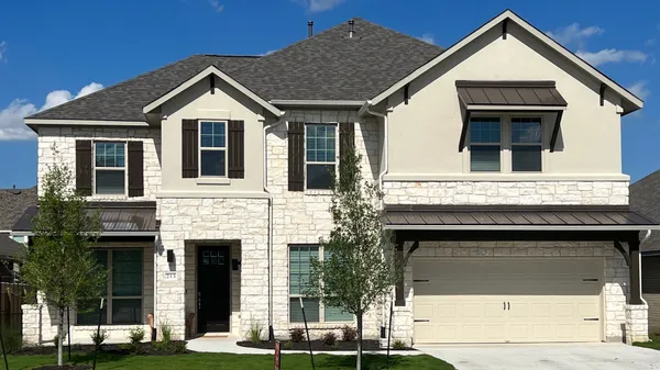 a front view of a house with a yard