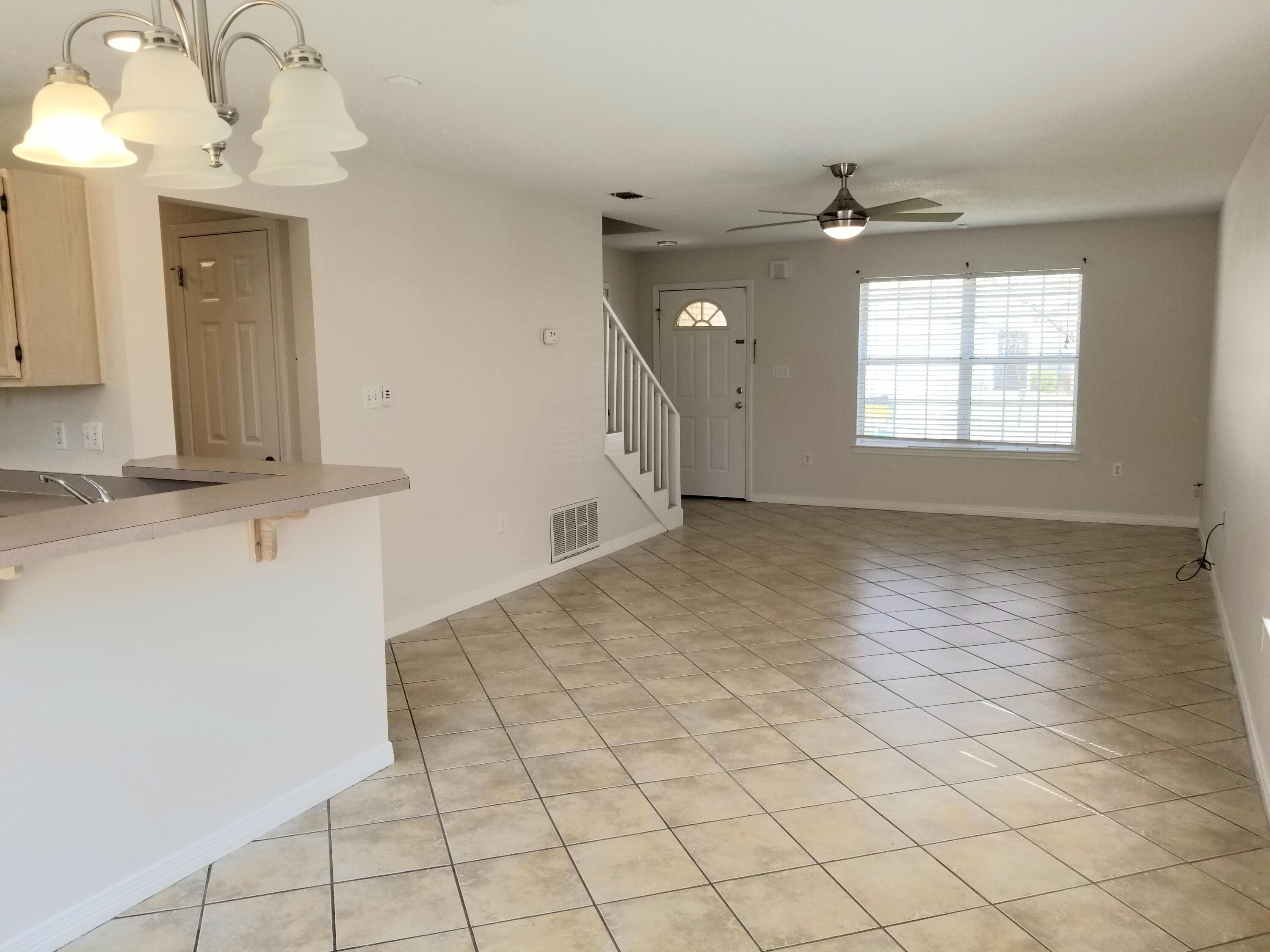 307 Rue Dianne Mary Esther, FL 32569 - Photo 2 of 17 an empty room with windows and fan