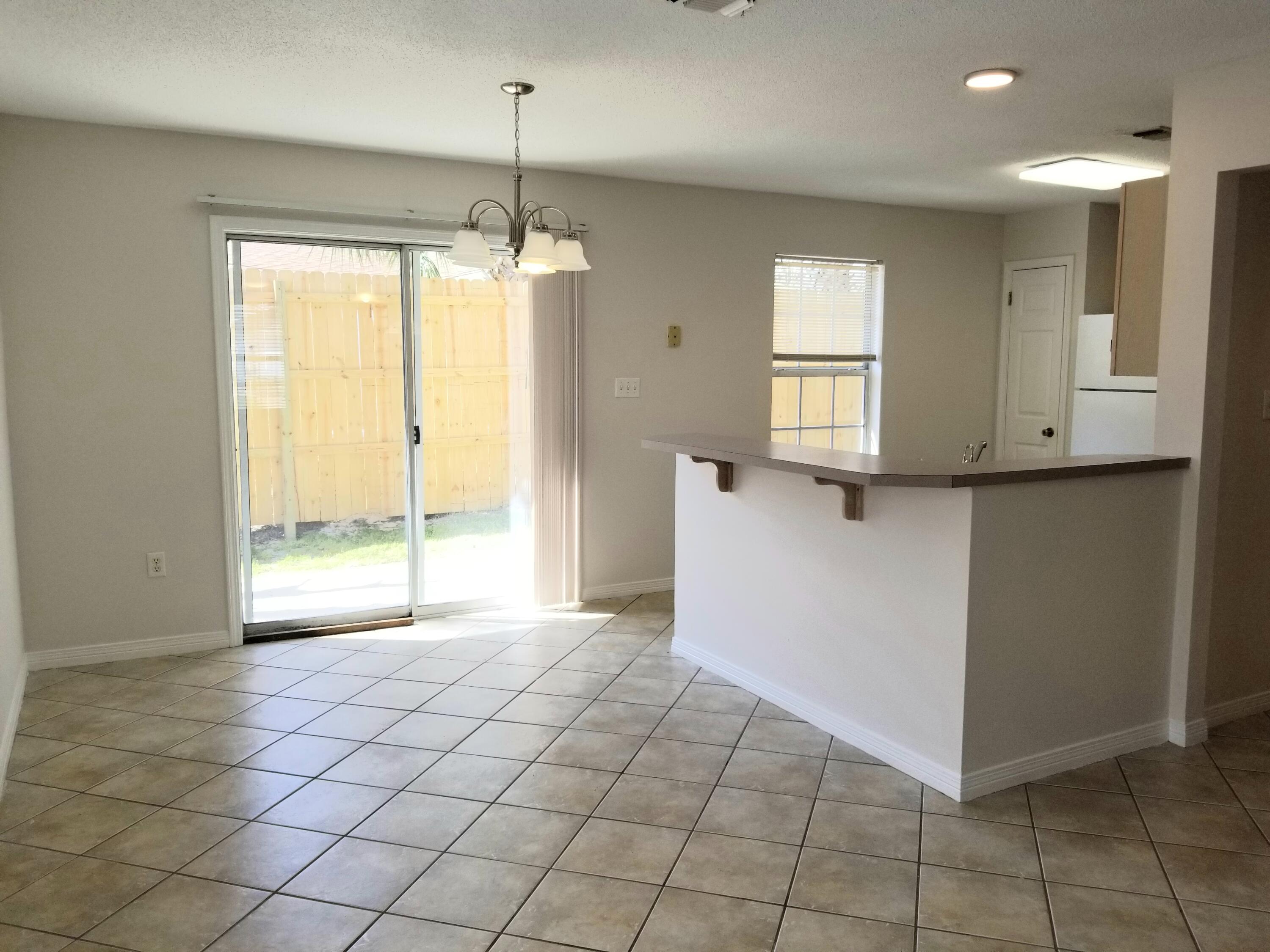 307 Rue Dianne Mary Esther, FL 32569 - Photo 9 of 17 a view of an empty room with window and chandelier