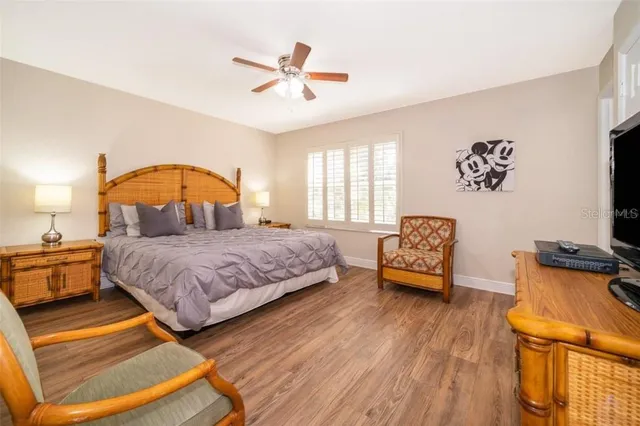 a bedroom with a bed a couch and dresser