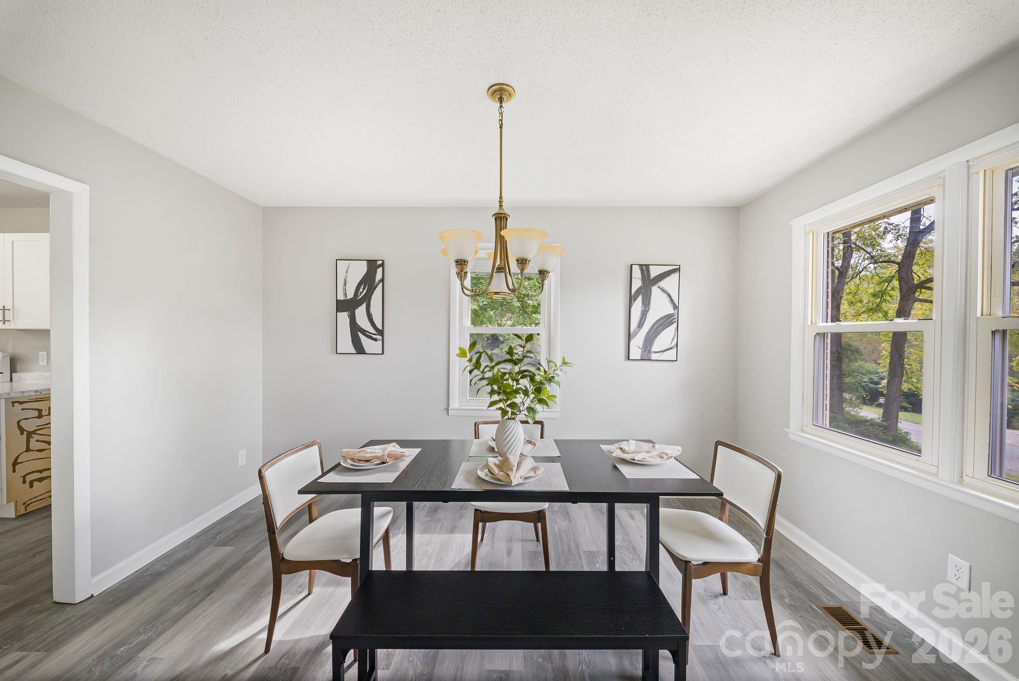 16 Sun Valley Court Alexander, NC 28701 - Photo 12 of 47 a dining room with furniture a window and wooden floor
