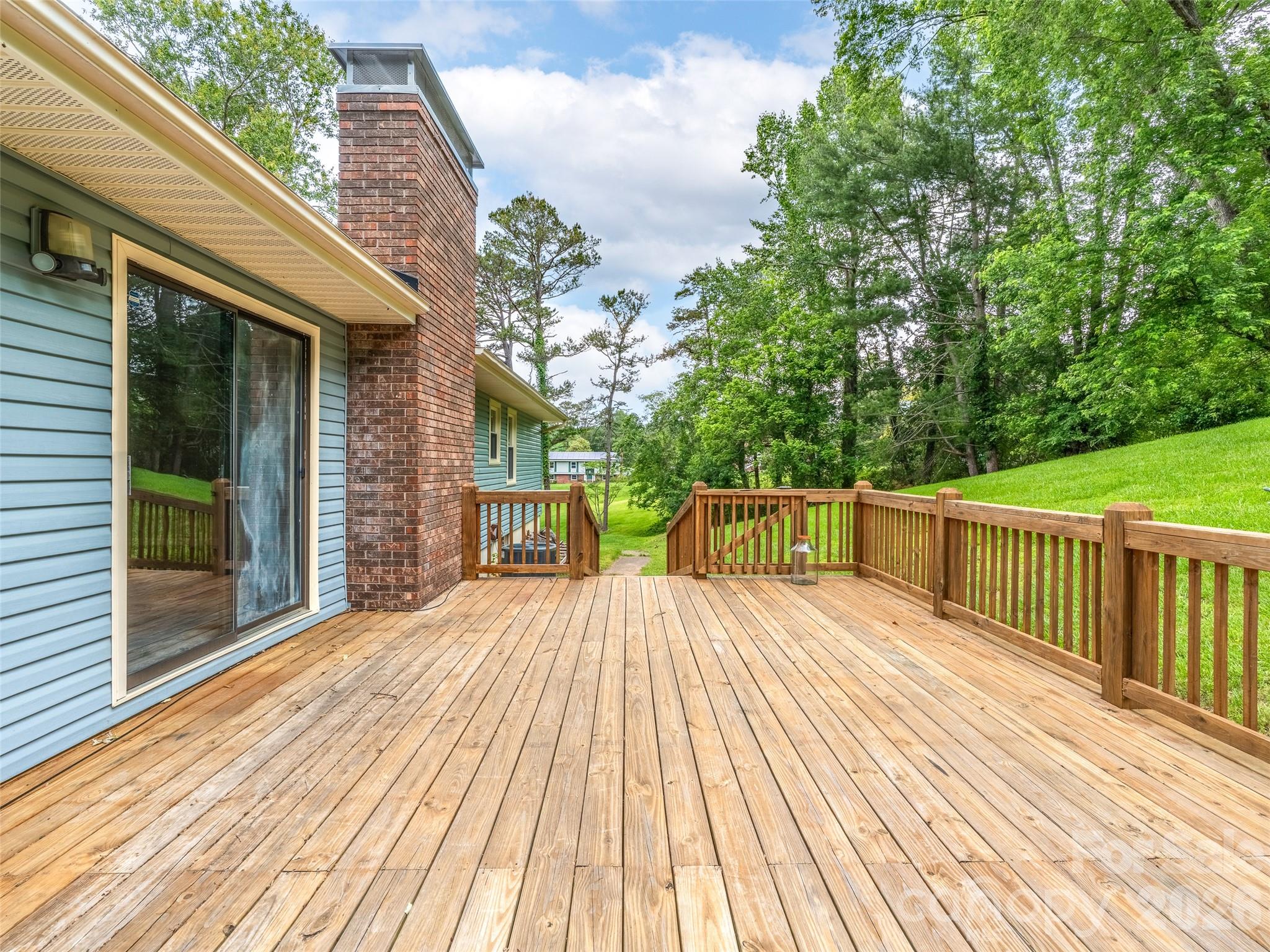 16 Sun Valley Court Alexander, NC 28701 - Photo 13 of 47 a view of backyard with a deck and wooden floor