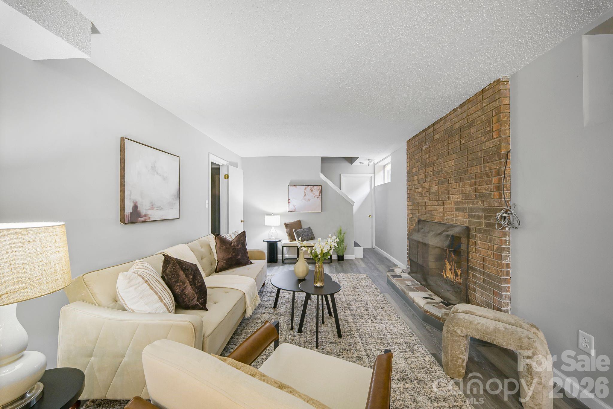 16 Sun Valley Court Alexander, NC 28701 - Photo 16 of 47 a living room with furniture and a fireplace