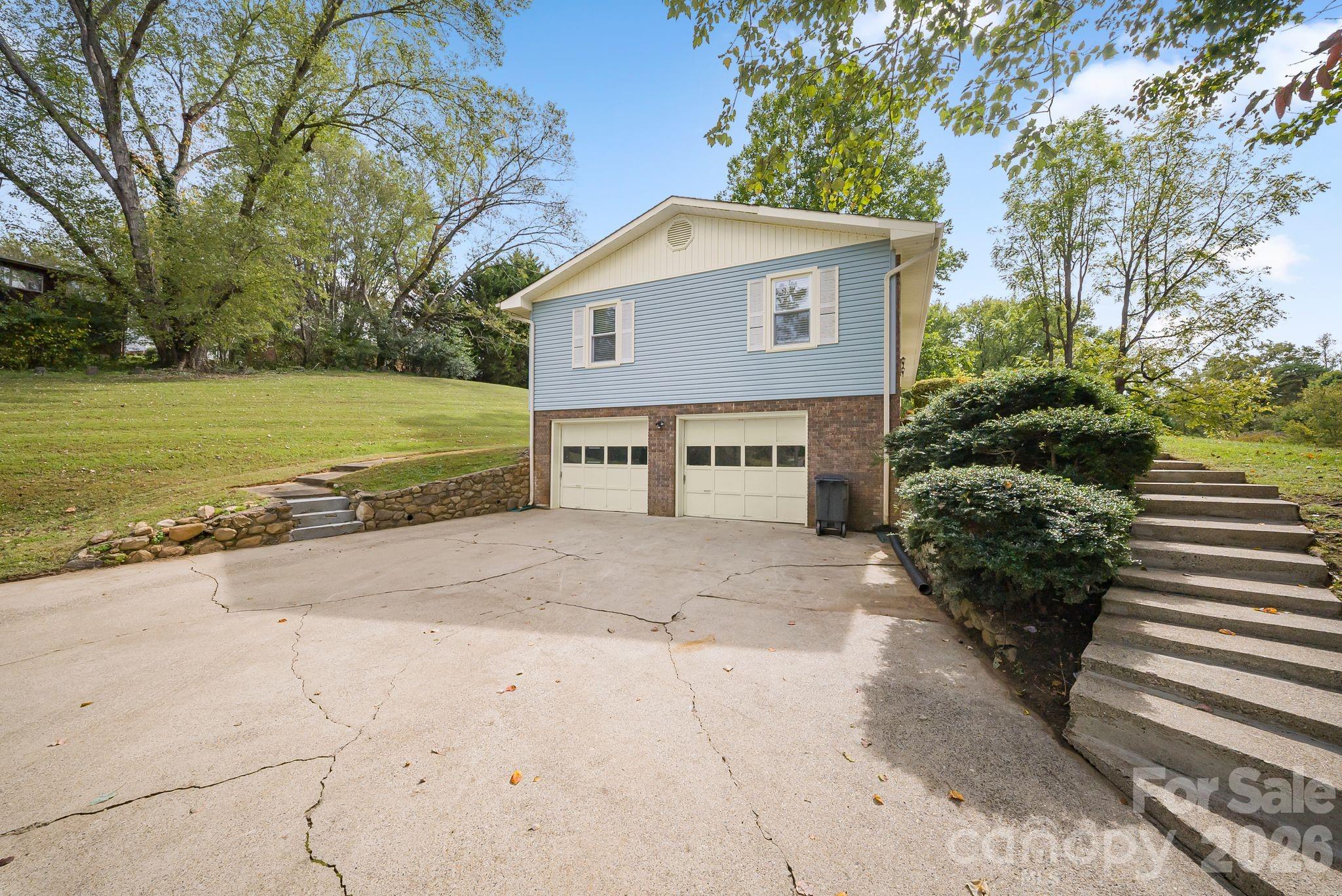 16 Sun Valley Court Alexander, NC 28701 - Photo 31 of 47 a front view of a house with a yard and garage