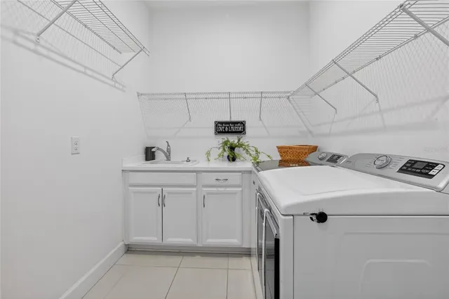 a living room with furniture a flat screen tv and kitchen view