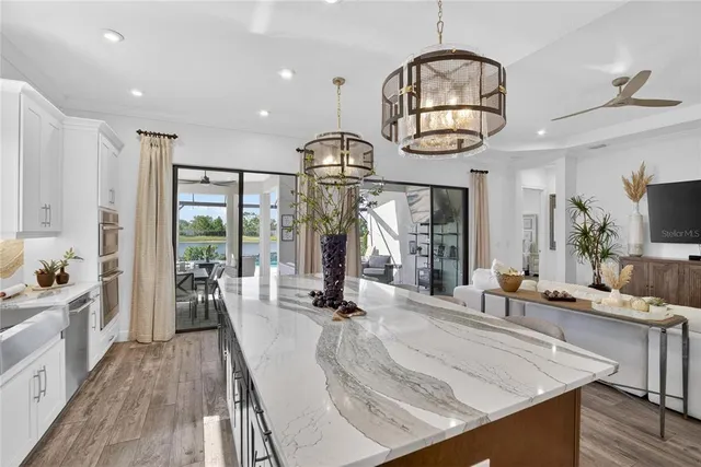 a living room with furniture and a floor to ceiling window