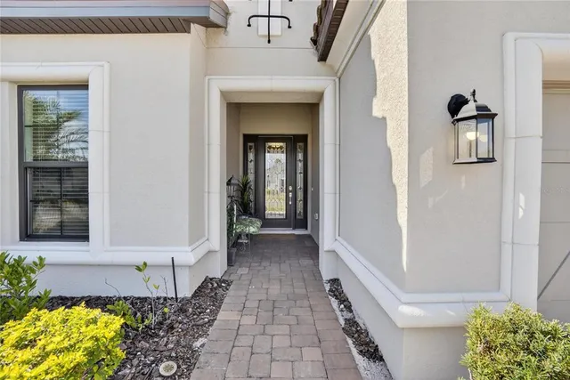 a view of a pathway of a house with potted plants