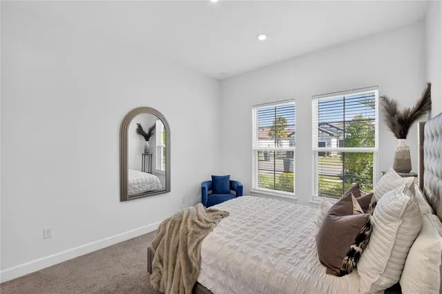 a bedroom with a bed and a flat tv screen