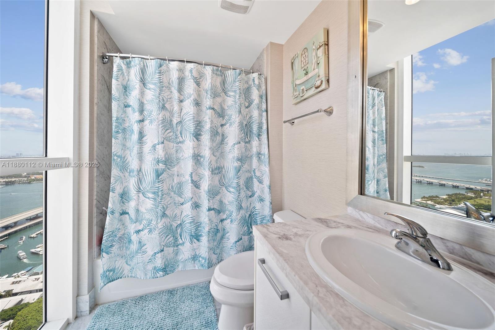244 Biscayne Boulevard, Unit 4608 Miami, FL 33132 - Photo 15 of 45 a bathroom with a granite countertop sink and a mirror