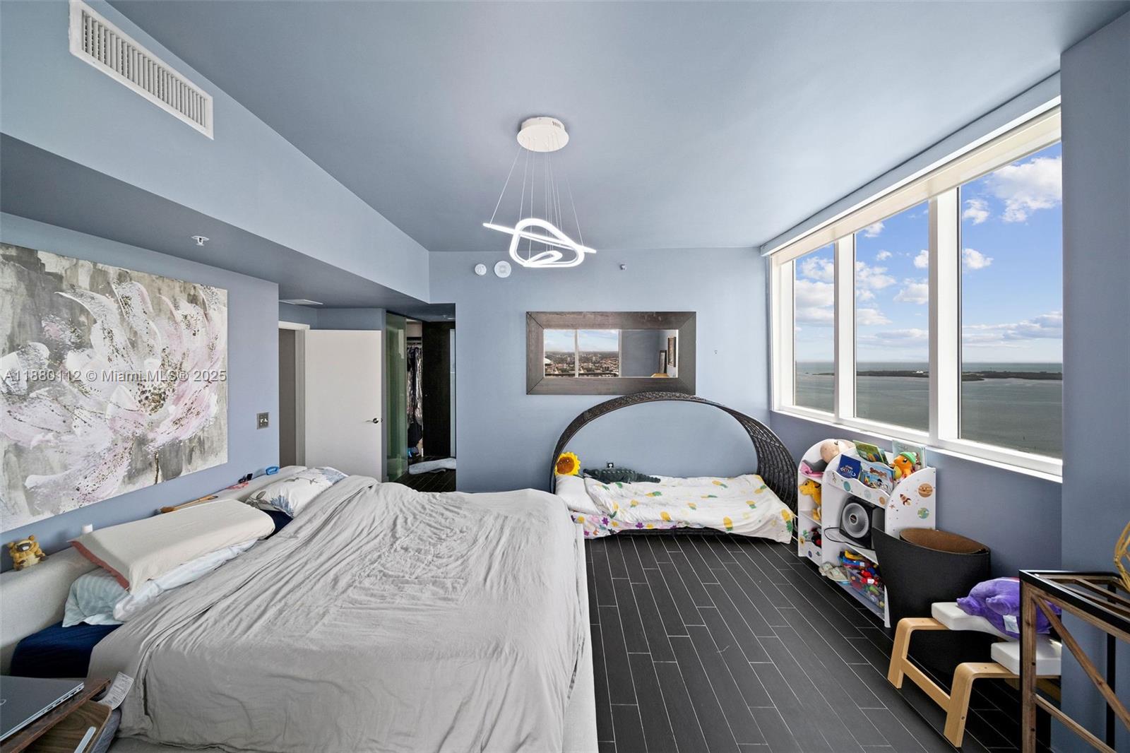 244 Biscayne Boulevard, Unit 4608 Miami, FL 33132 - Photo 23 of 45 a bedroom with a bed and wooden floor