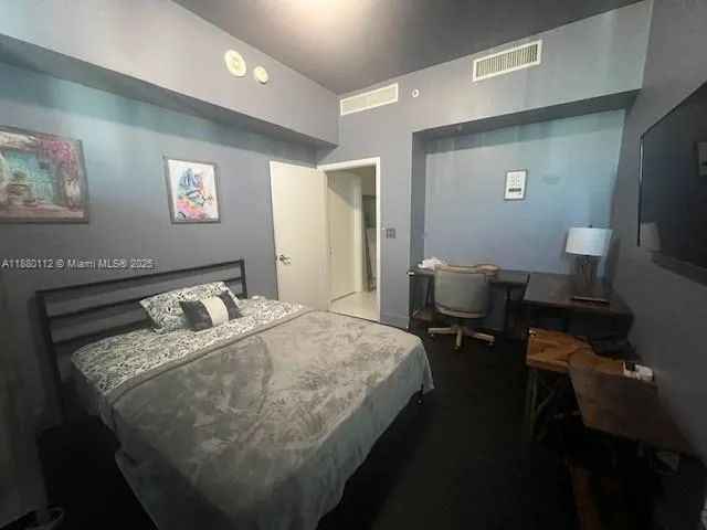 a bedroom with a bed and a table in it