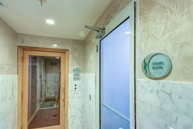 a hallway with furniture and a flat screen tv