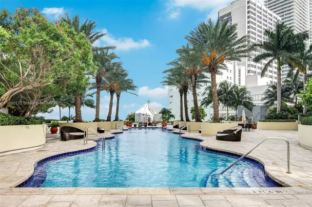 a swimming pool with outdoor seating and yard