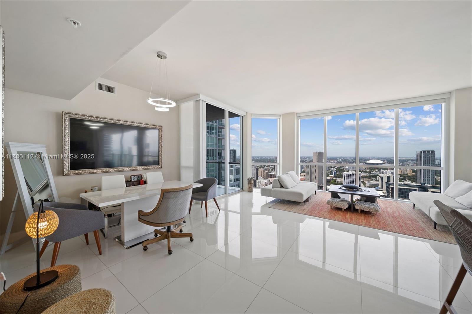 244 Biscayne Boulevard, Unit 4608 Miami, FL 33132 - Photo 5 of 45 a living room with furniture and a flat screen tv